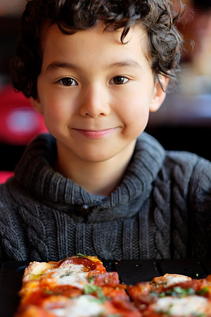 Kai enjoys some Serious Pie Pepperoni Pizza