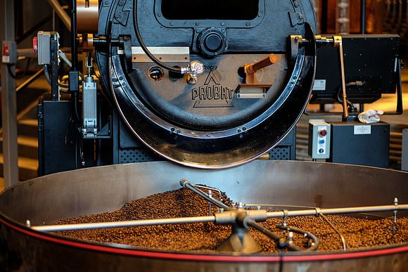 Hot beans are poured from Large-Batch Roaster to cool off
